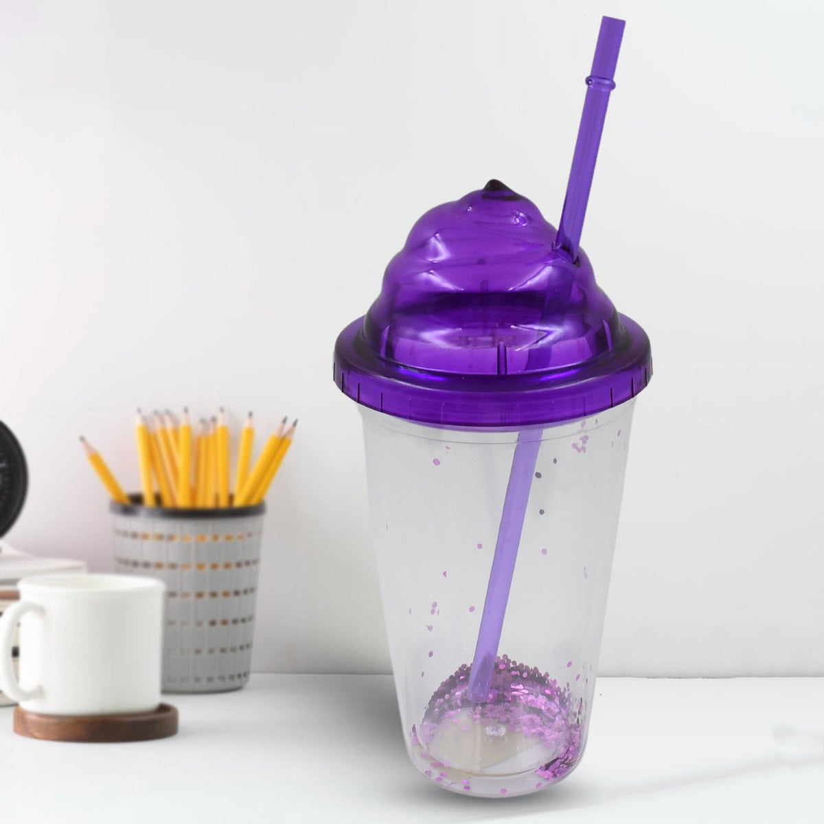Vibrant plastic cold drink tumbler with lid and reusable straw, showcasing mixed colors. Main image