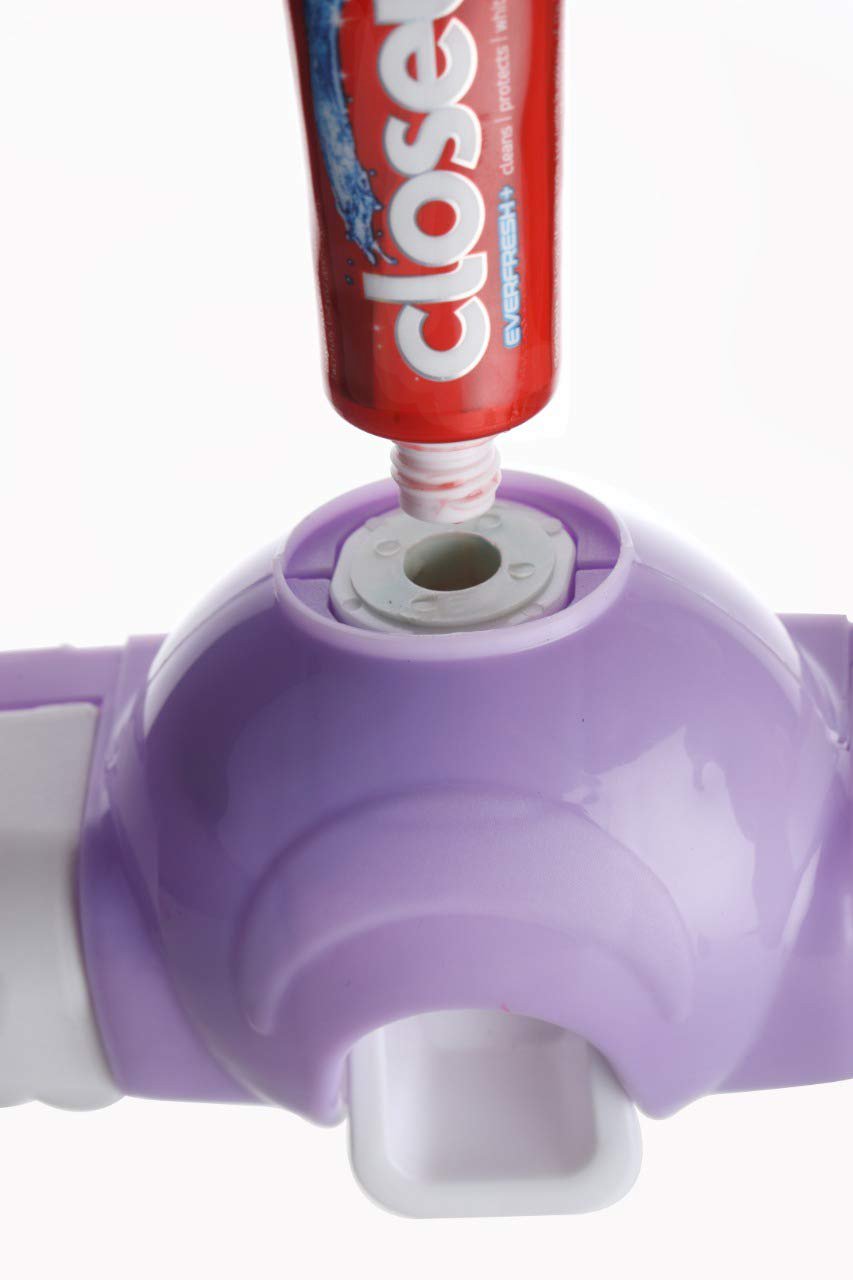 White automatic toothpaste dispenser and 4-slot toothbrush holder mounted on a wall. Main image