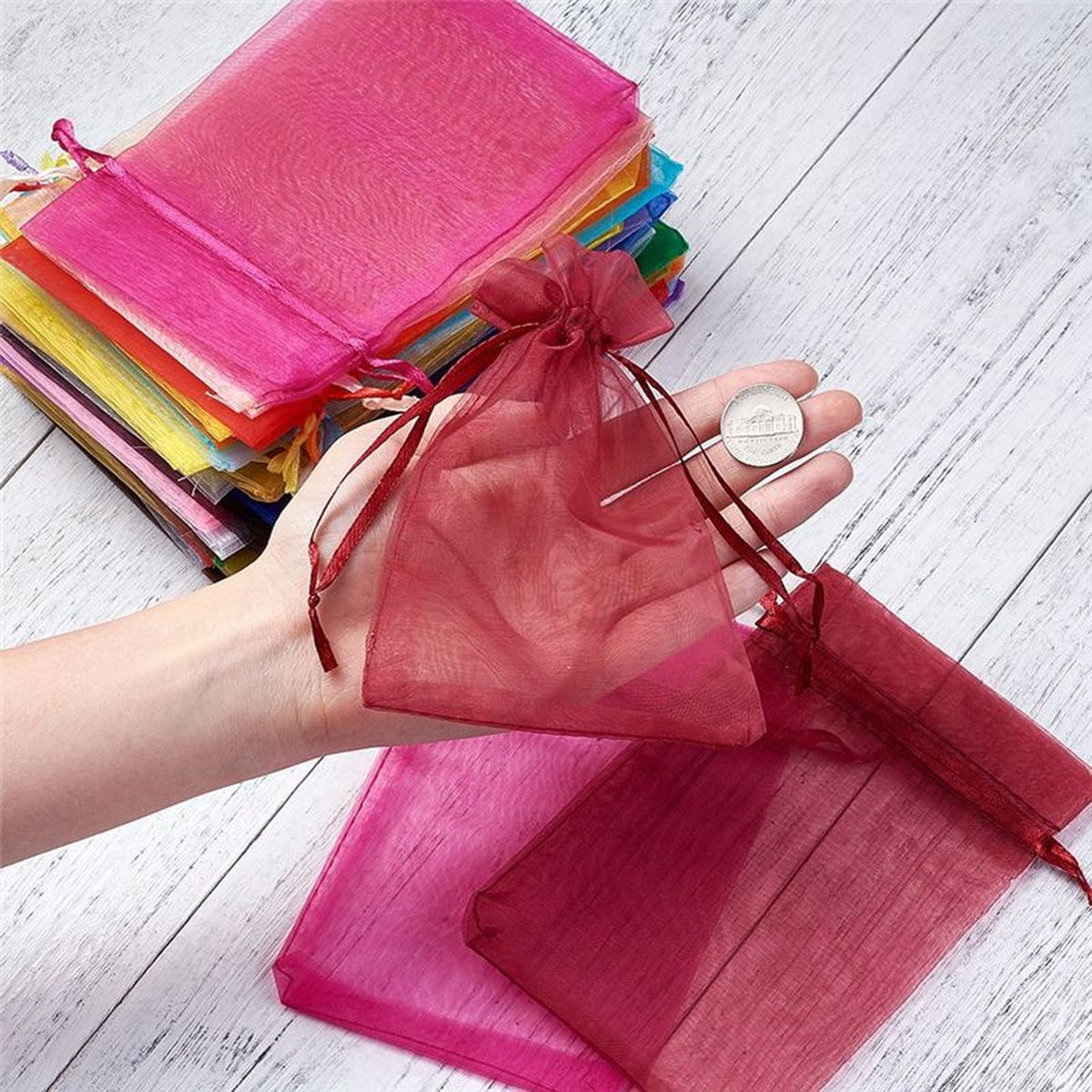 A stack of elegant organza gift bags, showcasing their sheer fabric and versatile design. Main image