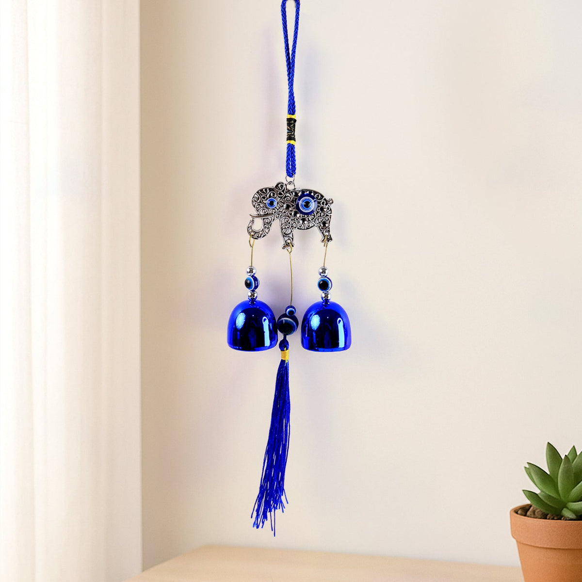 Metal evil eye wind chime hanging in home garden for protection and decor Main image